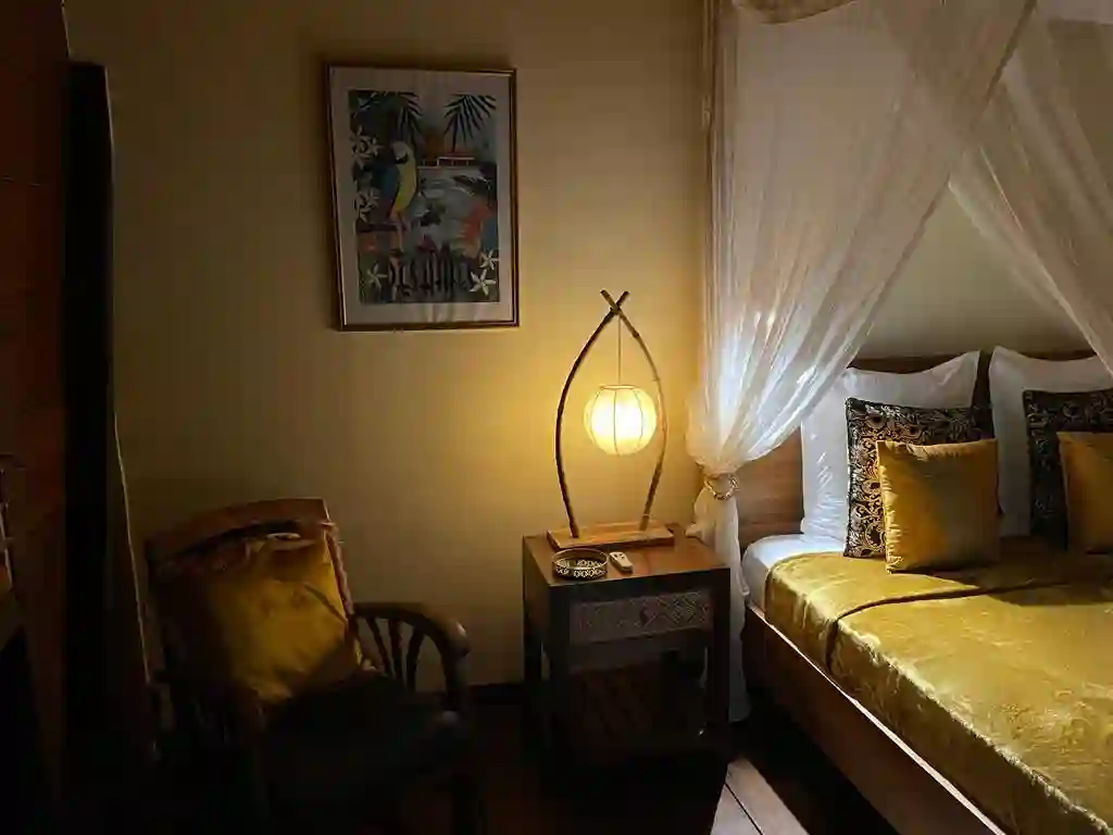 Two bedrooms with separate toilets and showers, queen-size bed, mosquito net, fan, and air conditioning.